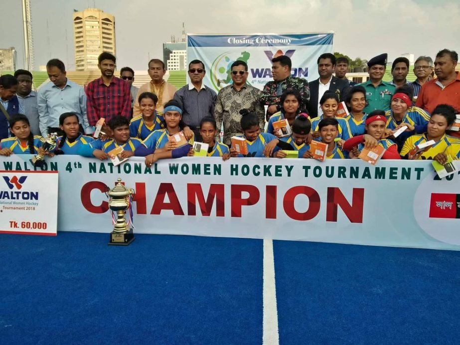 Members of Khulna Division, the champions of the Walton 4th National Women's Hockey Competition with the guests and officials of Bangladesh Hockey Federation pose for a photo session at Maulana Bhashani National Hockey Stadium on Monday. Khulna Division