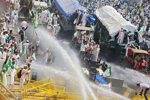 Police use water cannons to disperse farmers during a protest demanding better price for their produce on the outskirts of New Delhi on Tuesday.