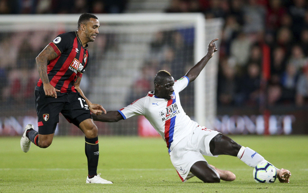 Bournemouth's Callum Wilson (left) and Crystal Palace's Mamadou Sakho battle for the ball during the English Premier League match at the Vitality Stadium, Bournemouth on Monday.