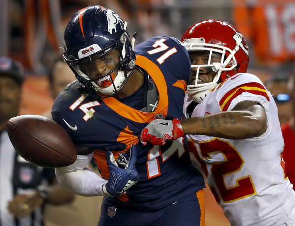 Denver Broncos wide receiver Courtland Sutton (14) can't make the catch as Kansas City Chiefs defensive back Orlando Scandrick (22) breaks up the pass during the second half of an NFL football game in Denver on Monday.