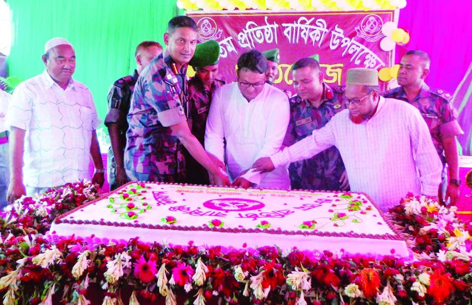 DINAJPUR (South): Colonel Md Sohrab Hossain Bhuiyan, Sector Commander, Boarder Guard Bangladesh (BGB), Dinajpur Sector and Md Shibli Sadik MP cutting cake in observance of the 36th founding anniversary of 29 Battalion of Fulbari Upazila yesterday.