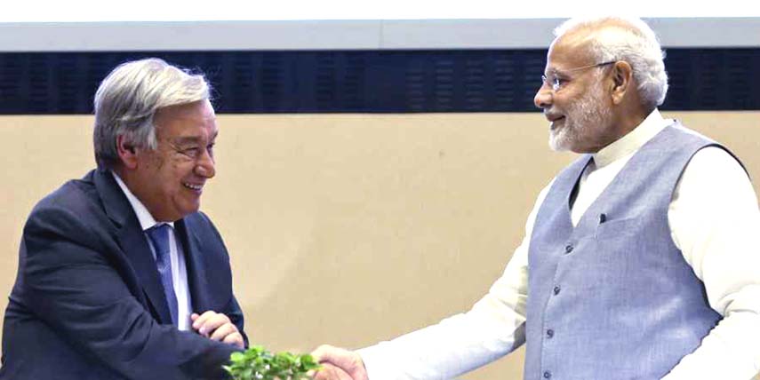 UN Secretary General Antonio Guterres, left and Indian Prime Minister Narendra Modi greet at the inaugural General Assembly of the International Solar Alliance (ISA) and the Global Re-investment summit on renewable energy in New Delhi on Tuesday.