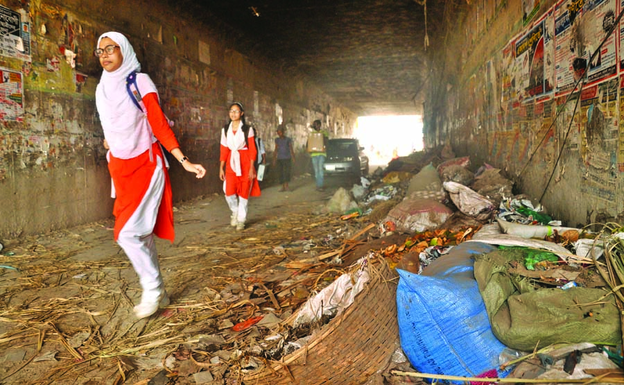 An under-pass route in city's Shanir Akhra turned into a garbage zone dumped by the locals and makeshift-shop owners. But the authority concern doesn't care to remove those garbage, spreading bad smell and creating environment hazards. This photo was ta