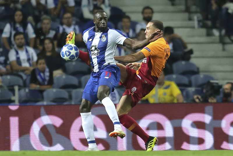 Galatasaray defender Maicon fights for the ball with Porto forward Moussa Marega (left) during the Champions League group D soccer match between FC Porto and Galatasaray at the Dragao stadium in Porto, Portugal on Wednesday.