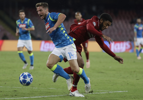 Napoli forward Dries Mertens (left) and Liverpool's Joe Gomez vie for the ball during the Champions League, group C soccer match between Napoli and Liverpool, at the San Paolo Stadium in Naples, Italy on Wednesday.