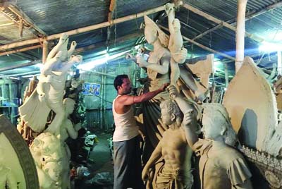 NARSINGDI: Idol makers passing busy time at puja mandops in Narsingdi. This snap was taken yesterday.