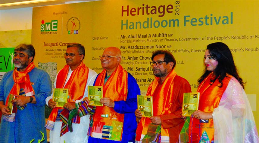 Finance Minister AMA Muhith along with Cultural Affairs Minister Asaduzzaman Noor, inaugurating the three-day long Heritage Handloom Festival-2018 jointly organised by SME Foundation in Association of Fashion Designers' Bangladesh (AFDB), at hall room of