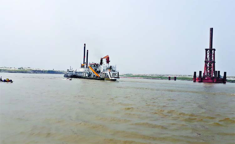 The Padma Bridge project authorities seen dredging at Lauhajang point to restore navigability in Shimulia-Kathalbari River route. The photo was taken on Friday.