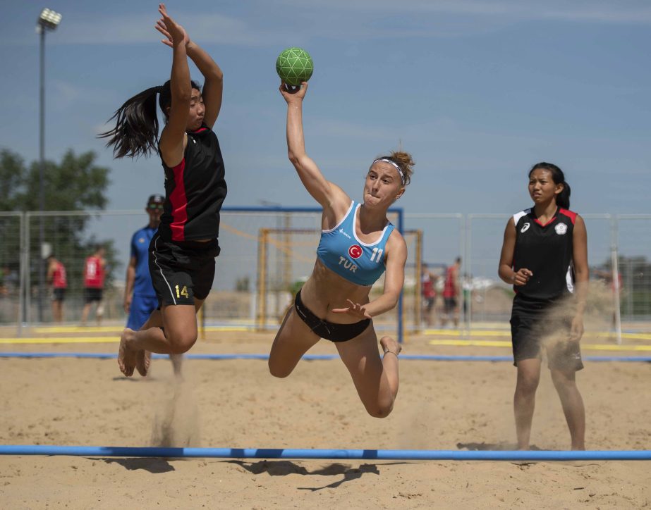 Turkish athlete Elif Dalkic is suspended in the air as she plays a shot during a practice session at the Beach Handball Arena in Tecnopolis Park, ahead of the III Youth Olympic Games in Buenos Aires, Argentina on Friday. Promoted by the International Olym