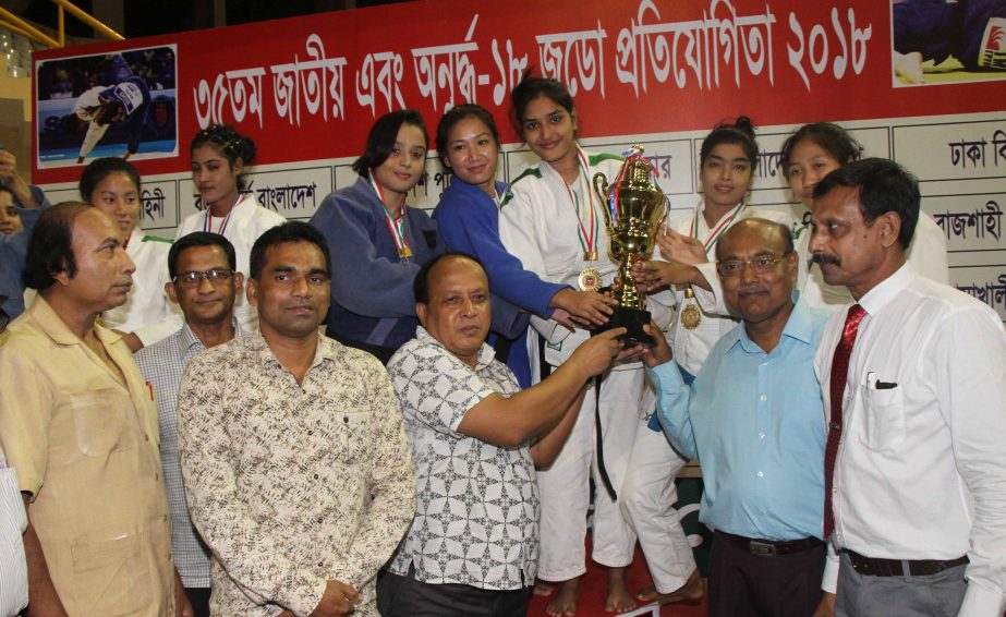 Members of Bangladesh Ansar, the champions of the Women's Division (Senior) of the 35th National Judo Championship with the guests and officials of Bangladesh Judo Federation pose for a photo session at the Shaheed Suhrawardy Indoor Stadium in the city'