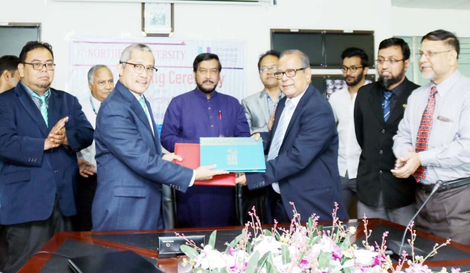 Vice Chancellor of University of Malaysia Pahang Prof Dato' Shri Ts Dr Daing Nasir Ibrahim and Prof Dr Anwar Hossain, Vice-Chancellor of Northern University Bangladesh exchanging MoA documents after signing it in a ceremony held in the city on Wednesday.