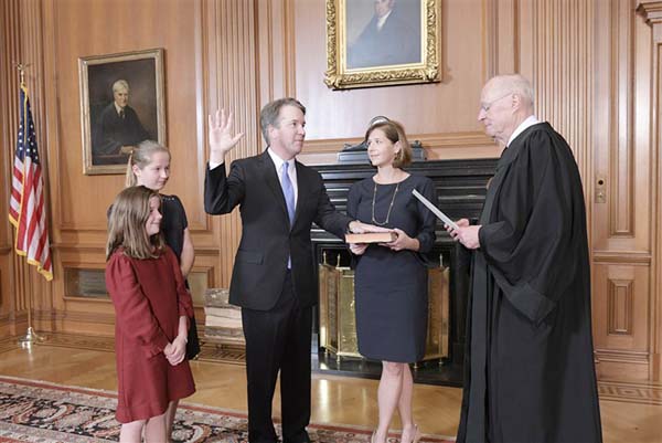 Brett Kavanaugh is sworn in as an Associate Justice and wife Ashley Kavanaugh holds the Bible.