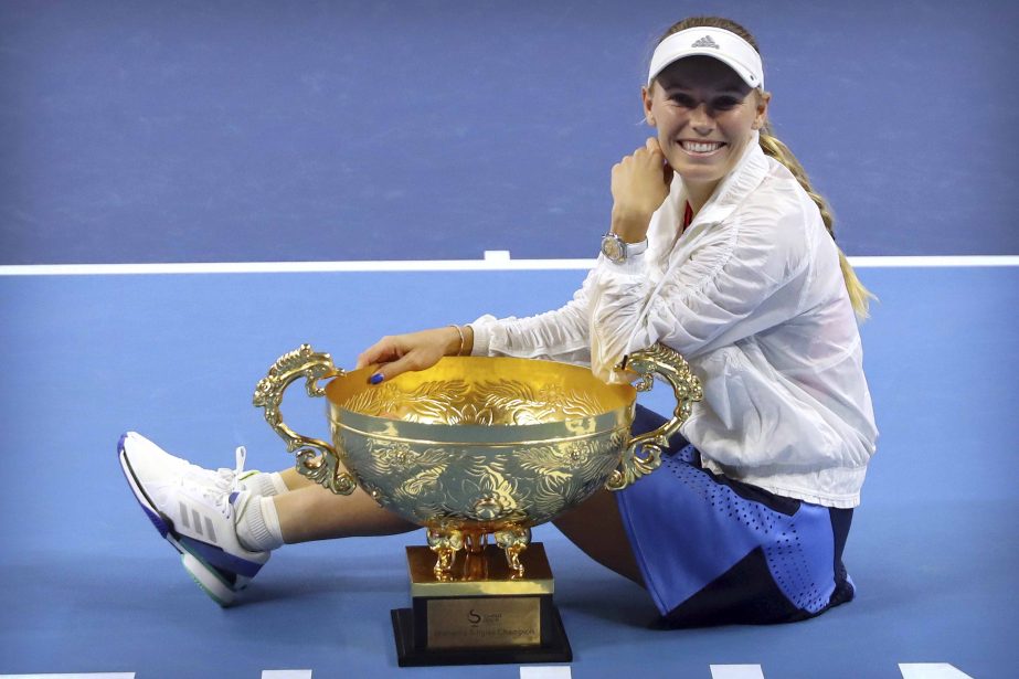 Caroline Wozniacki of Denmark poses with the winner's trophy after beating Anastasija Sevastova of Latvia in the women's singles final in the China Open at the National Tennis Center in Beijing on Sunday.