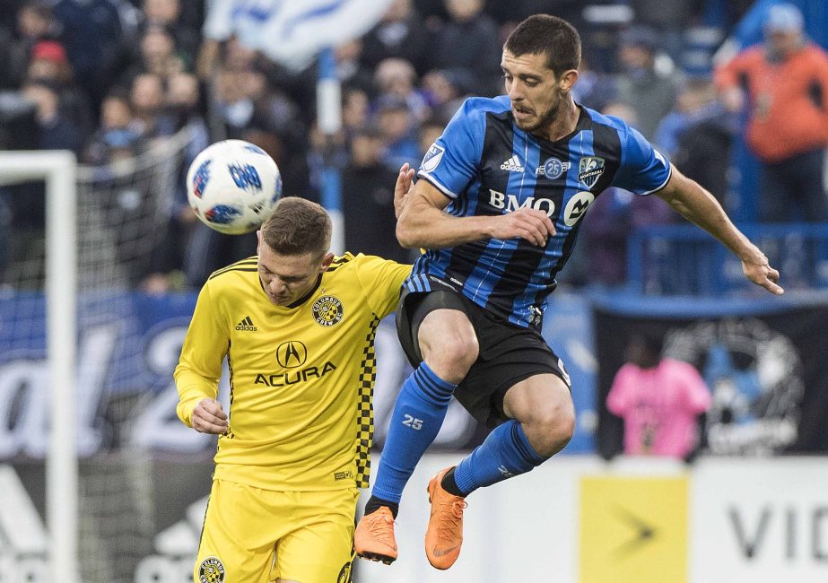 Montreal Impact's Alejandro Silva (right) challenges Columbus Crew SC's Wil Trapp during second half MLS soccer action in Montreal on Saturday.