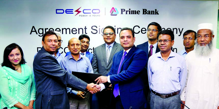 Shams A Muhaimin, Head of Transaction Banking of Prime Bank Limited and S M Zamil Hussain, Company Secretary of DESCO, exchanging an agreement documents at the Banks head office in the city recently. Under the deal, the Bank will collect DESCO electricity