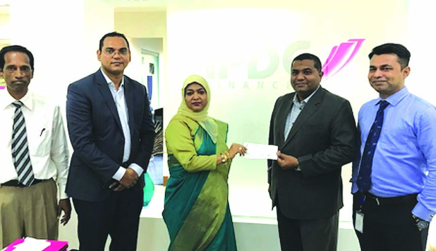 Mohammodi Khanam, Managing Director of Prime Insurance Company Limited, handing over cheques of Health Insurance Claims to Rizwan Dawood Shams, DMD of IPDC Finance Limited at its head office in the city recently. Senior officials from both the organizatio