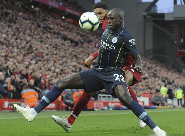 Manchester City's Benjamin Mendy (front) and Liverpool's Joe Gomez vie for the ball during the English Premier League soccer match between Liverpool and Manchester City at Anfield stadium in Liverpool, England on Sunday.