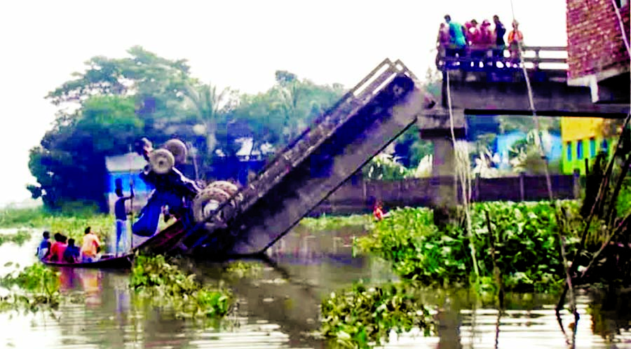 A brick laden truck plunges into a river as bridge collapses due to pressure of heavy vehicle on Batakandi road at Kadamtoli area under Daudkandi upazila of Cumilla on Monday. Driver of the truck was killed.