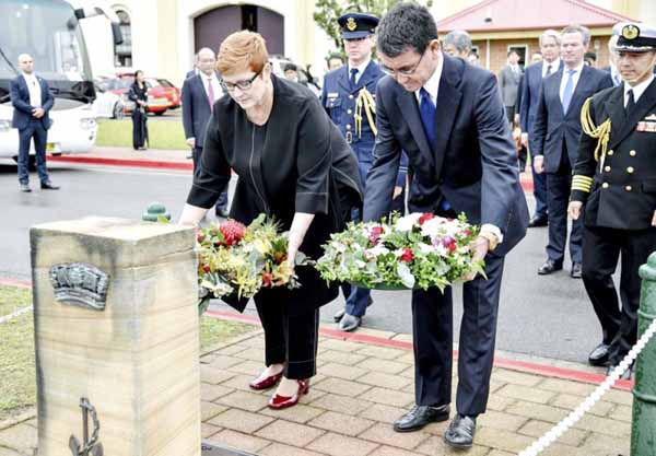 Japanese Foreign Minister Taro Kono, right, and Australian Foreign Minister Marise Payne lay wreaths at HMAS Kuttabul in Sydney on Wednesday.
