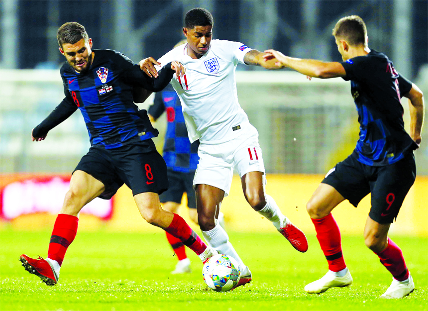 England's Marcus Rashford (center) vies for the ball with Croatia's Mateo Kovacic (left) and Croatia's Duje Cop during the UEFA Nations League soccer match between Croatia and England at Rujevica stadium in Rijeka, Croatia on Friday.