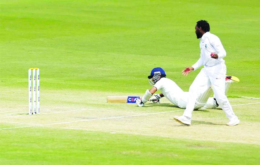 Indian cricketer Ajinkya Rahane dives to reach his crease during the second day of the second cricket Test match between India and West Indies in Hyderabad, India on Saturday.