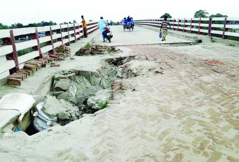 NAOGAON: The four hundreds meter long link Road of Bailtullah Bridge at Raninagar Upazila point needs immediate repair as it has development pathholes in many places which may occur accident any time. This snap was taken on Saturday.