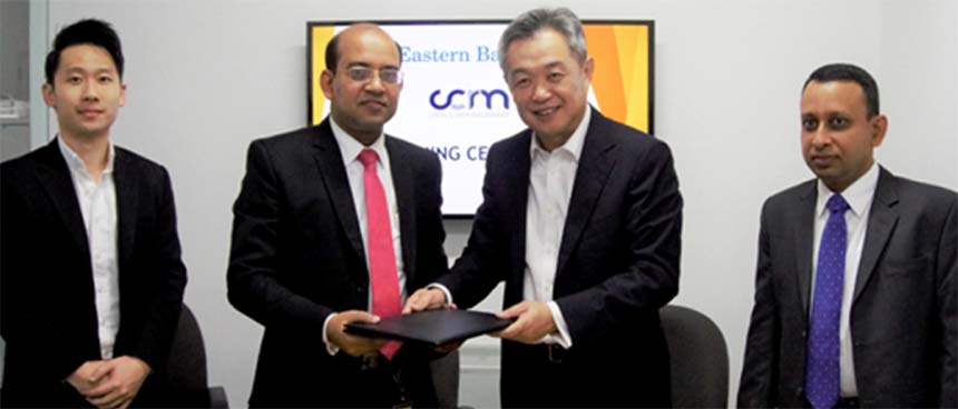 Md. Obaidul Islam, Head of Financial Institutions and Offshore Banking of Eastern Bank Limited (EBL) and Tan Kah Chye, Chairman of CCR Manager, exchanging an agreement signing document in Singapore recently. Under the deal, paves the way for EBL to join
