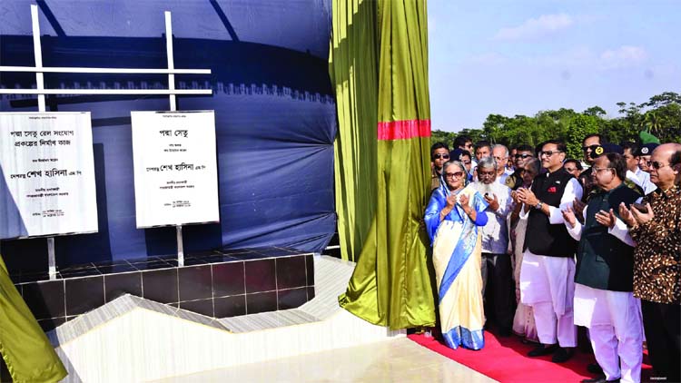Prime Minister Sheikh Hasina offering the munajat after unveiling the name plaque of Padma Bridge and Padma Bridge rail construction project on Sunday.
