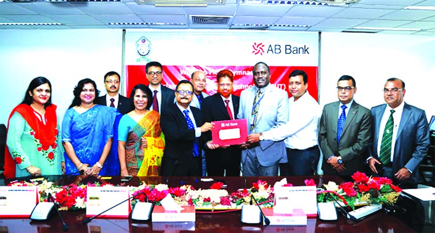 Sajjad Hussain, DMD of AB Bank Ltd, handing over a cheque to Dr Omar Jah, Vice Chancellor (acting) of Islamic University of Technology (IUT) for a wooden floor gymnasium of the University. Shamshia I Mutasim, DMD of the Bank, Maruful Islam Bhuiyan, FCA, C