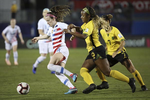 United States midfielder Rose Lavelle controls the ball while being defended by Jamaica defender Jadya Matthews (15) and midfielder Chinyelu Asher (7) during the first half of a soccer match at the CONCACAF women's World Cup qualifying tournament in Fris