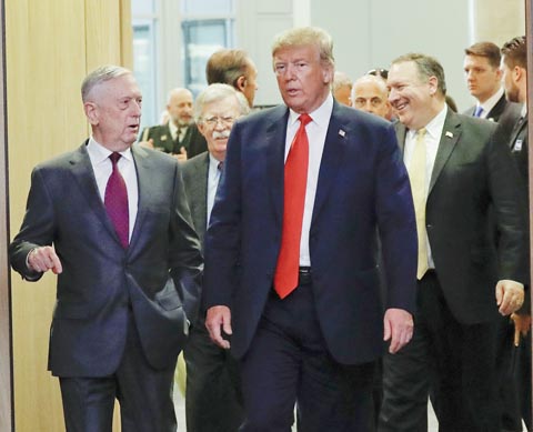 U.S. President Donald Trump, right, walks in with Defense Secretary Jim Mattis, left, as they arrive to attend the multilateral meeting of the North Atlantic Council, on Wednesday in Brussels.