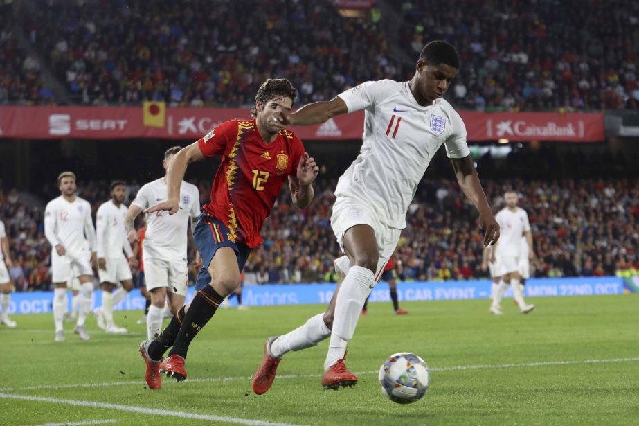 England's Marcus Rashford (right) and Spain's Marcos Alonso challenge for the ball during the UEFA Nations League soccer match between Spain and England at Benito Villamarin stadium in Seville, Spain on Monday.