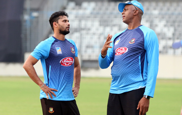 Coach of Bangladesh National Cricket team Courtney Walsh (right) talking to pacer Masheafe Bin Mortaza during the practice session of Bangladesh National Cricket team at the Sher-e-Bangla National Cricket Stadium in the city's Mirpur on Tuesday.