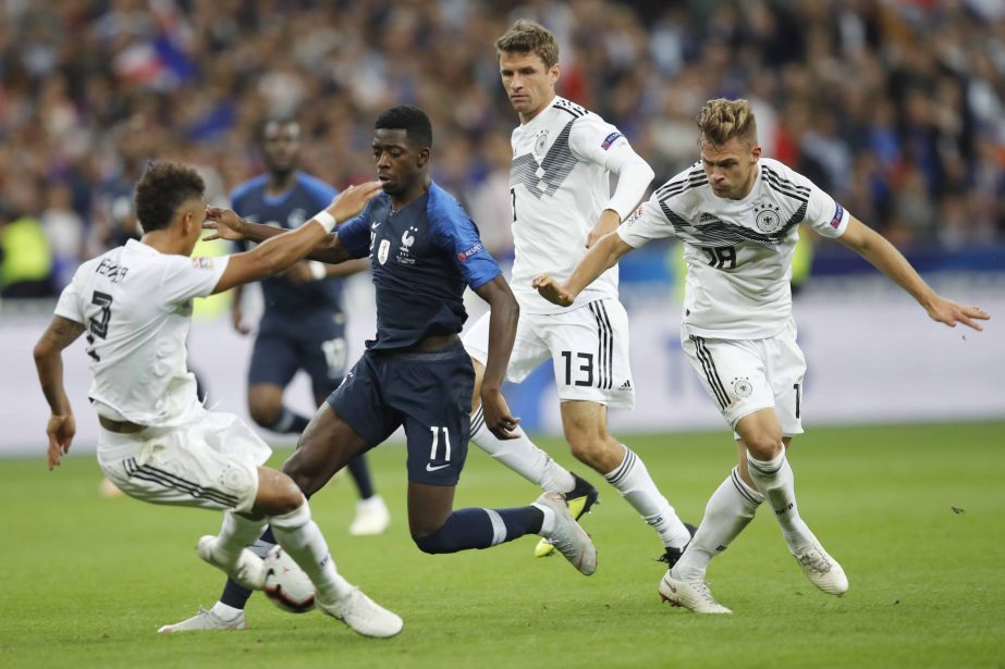 France's Ousmane Dembele (2nd left) challenges for the ball with German player, Thilo Kehrer (left) Thomas Mueller (2nd right) and Joshua Kimmich during a UEFA Nations League soccer match between France and Germany at Stade de France stadium in Saint Den