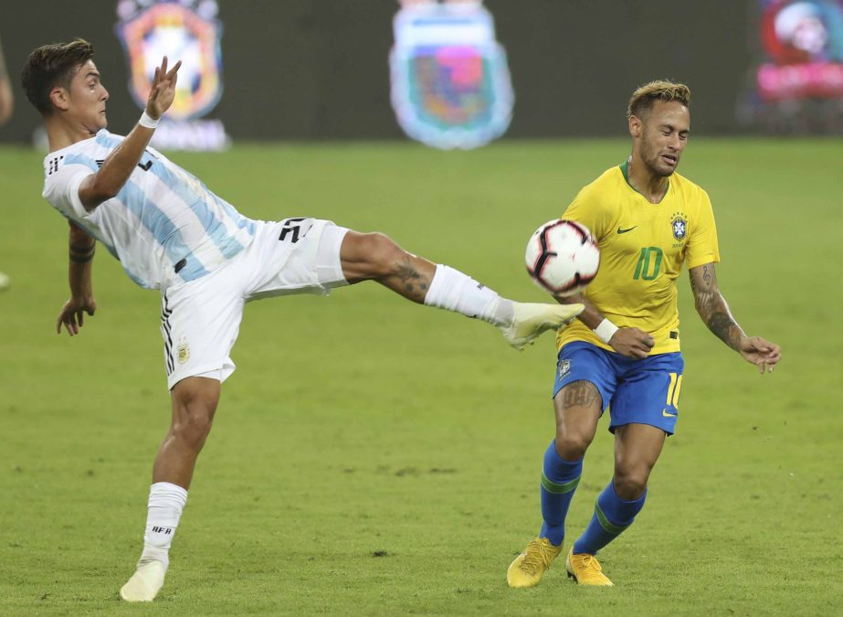 Argentina's Paulo Dybala (left) controls the ball against Brazil's Neymar during a friendly soccer match between Brazil and Argentina at King Abdullah stadium in Jiddah, Saudi Arabia on Tuesday.