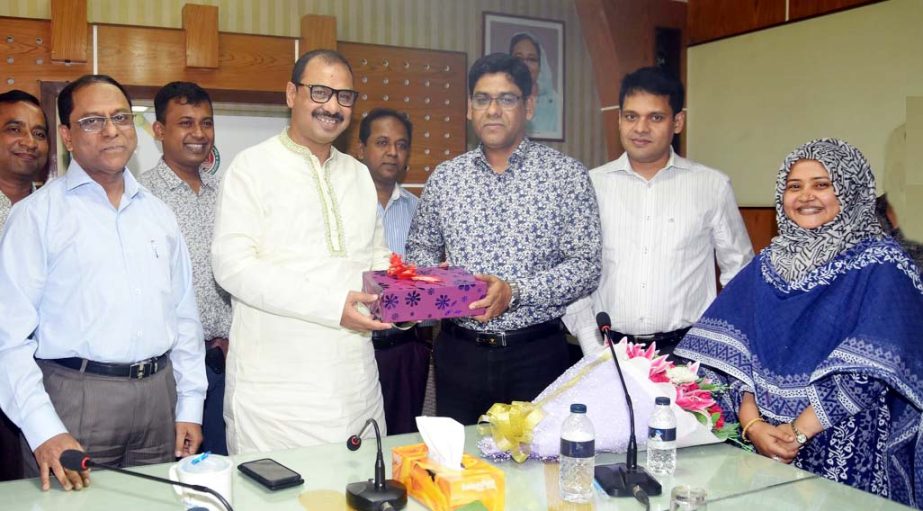 CCC Mayor A J M Nasir Uddin greeting outgoing Chief Revenue Officer of CCC Dr Md Mustafizur Rahman at a reception on Wednesday.