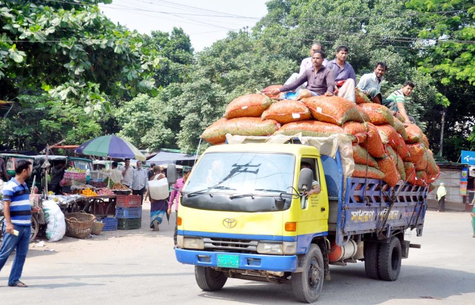 Passengers riding on roof of a truck at Tigerpass area in Chattogram City. This picture was taken yesterday.