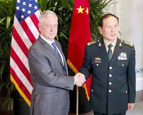 U.S. Defense Secretary Jim Mattis, left, meets Chinese Defense Minister Wei Fenghe in Singapore on Thursday.