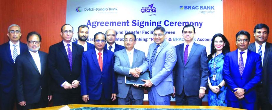 Nazmur Rahim, Head of Retail Banking of BRAC Bank Limited and Md. Abul Kashem Khan, SEVP of Dutch-Bangla Bank Limited (DBBL), exchanging an agreement signing documents at DBBL head office in the city on Wednesday. Under the deal, clients of BRAC Bank will