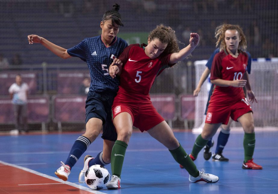 In this photo provided by the OISIOC, Sara Oino of Japan and Carolina Rocha of Portugal fight for the ball during the Futsal Women's Tournament Gold Medal Match between Portugal and Japan, during the Youth Olympic Summer Games in Buenos Aires, Argentina