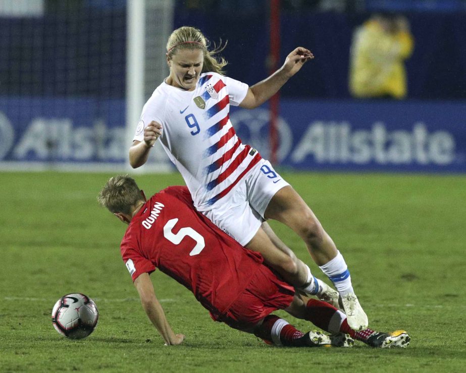 Canada defender Rebecca Quinn (5) slides into USA midfielder Lindsey Horan (9) in the first half of the final of the CONCACAF Women's Soccer Championship in Frisco, Texas on Wednesday.