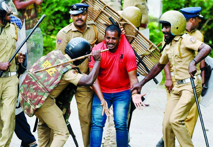 Indian police beat a Hindu activist in protests over women's access to a Hindu temple in Kerala.