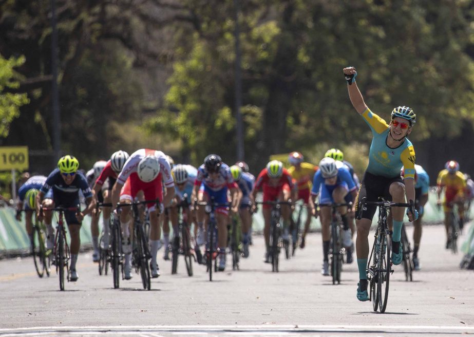 In this photo provided by the OISIOC, Gleb Brussenskiy of Kazakhstan celebrates his team's gold medal win as he finishes in the Cycling Men's Combined Criterium at Bosques de Palermo, during the Youth Olympic Summer Games in Buenos Aires, Argentina on