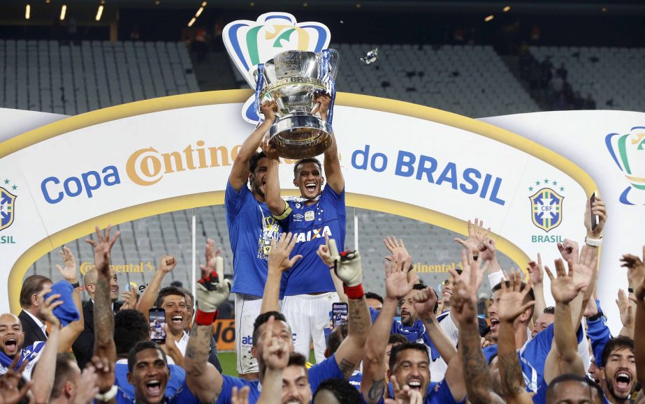 Cruzeiro players lift the Brazil Cup as they celebrate their victory over Corinthians in Sao Paulo, Brazil on Wednesday.