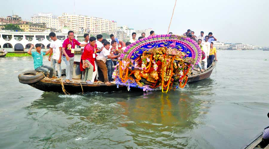 People of Hindu community immersing the idol of goddess Durga at the River Buriganga at Sadarghat point on Friday evening.