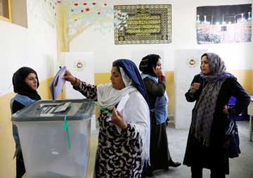 An Afghan woman casts her vote during parliamentary elections at a polling station in Kabul, Afghanistan on Saturday.