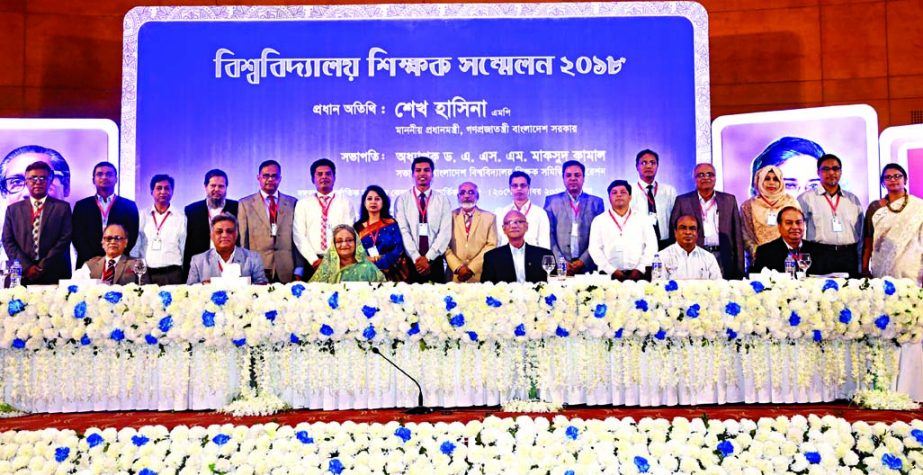 Prime Minister Sheikh Hasina poses for a photograph along with the leaders of Bangladesh University Teachers' Federation conference at Bangabandhu International Conference Centre on Saturday. PID photo