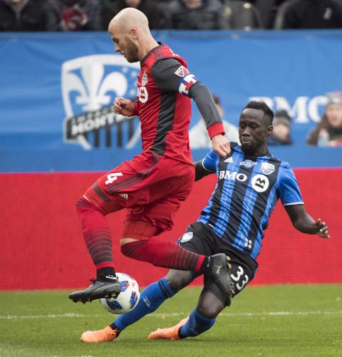 Toronto FC's Michael Bradley (left) challenges Montreal Impacts Bacary Sagna during first half MLS soccer action in Montreal on Sunday.