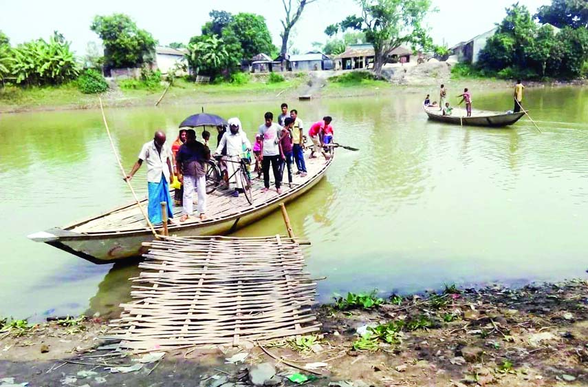 RANINAGAR (Naogaon): An iron bridge is needed immediately as people of Kujail- Atailkula Union have to use boats for the communication. This snap was taken yesterday.