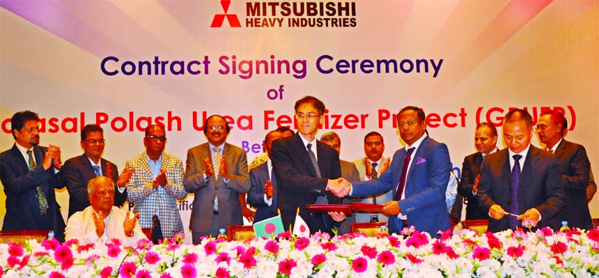 Shah Md. Aminul Haq on behalf of Bangladesh Chemical Industries Corporation (BCIC) and Hajime Nagano, Senior Vice-President of Ms MHI, Japan, exchanging and agreement signing document to establish a new granular urea fertilizer factory with the capacity